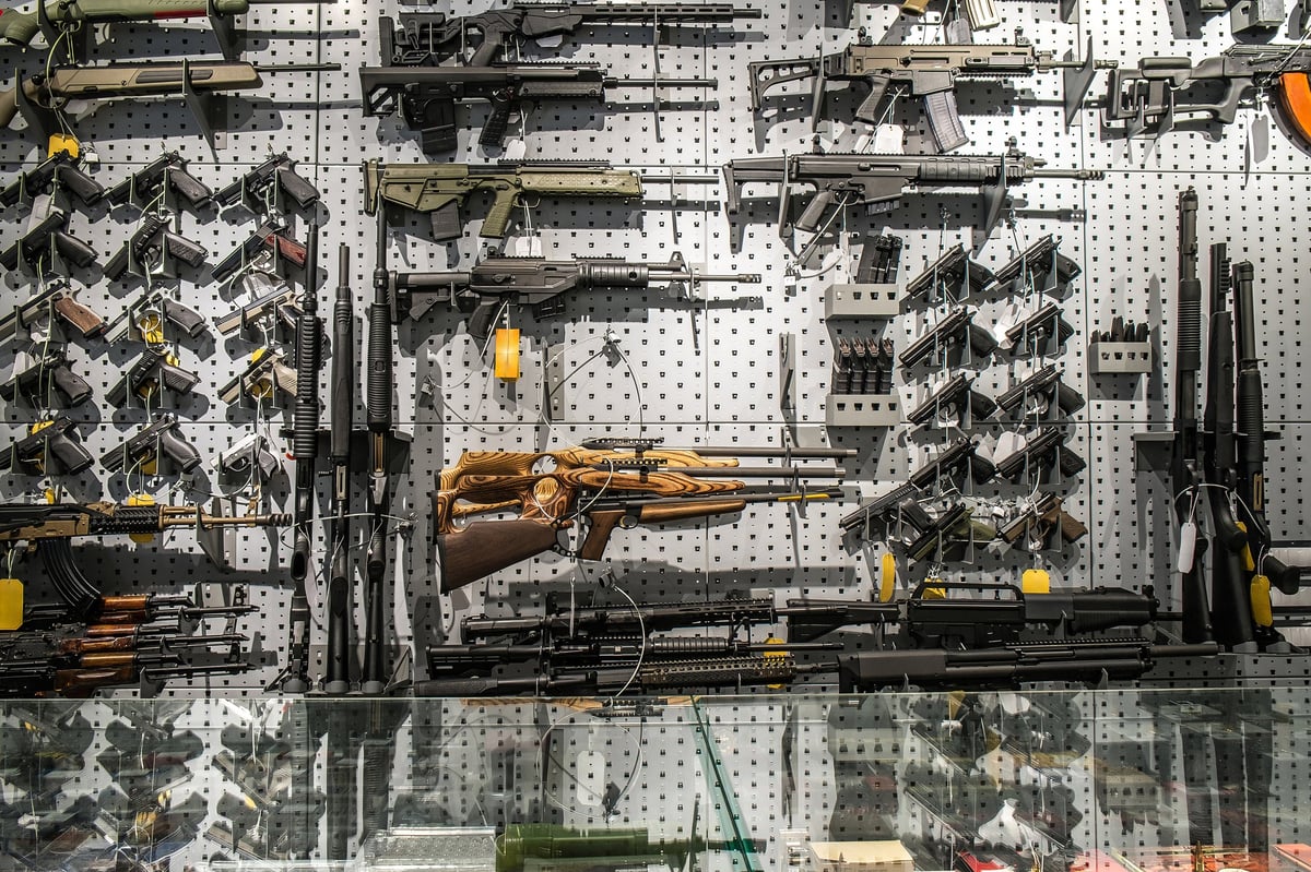 Premium firearms store interior with rifles and shotguns on wall display