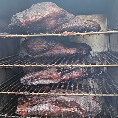 Smoked brisket with charred bark fresh from the smoker